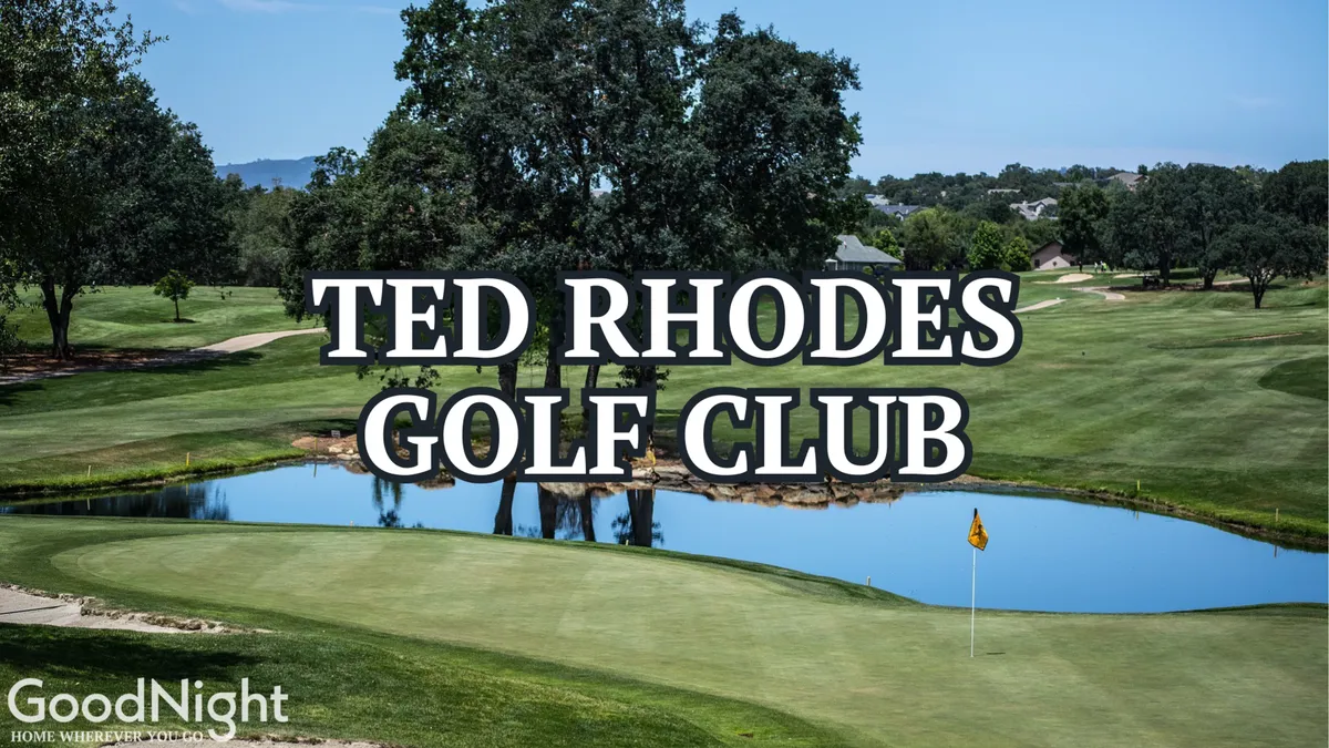 A scenic view of a green golf course with a water feature and trees in the distance. The setting exudes relaxation, and the flag on the green signals a spot for friendly competition or family fun. The mood is peaceful and inviting, ideal for outdoor activities.