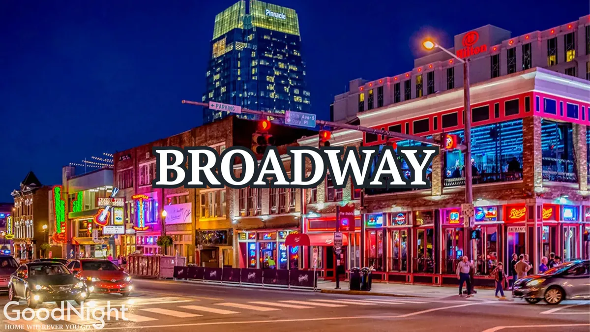 A dynamic night scene on a bustling Nashville street, illuminated by neon signs and filled with people enjoying restaurants and entertainment venues. The tall buildings and vibrant crowds capture the energy and diversity of Nashville's nightlife.