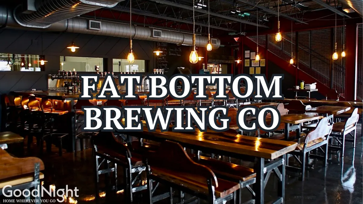 A welcoming interior of a craft beer bar with long wooden tables, industrial lighting, and a relaxed bar area. The atmosphere suggests a perfect spot for socializing, tasting local beers, and starting a night out with friends.